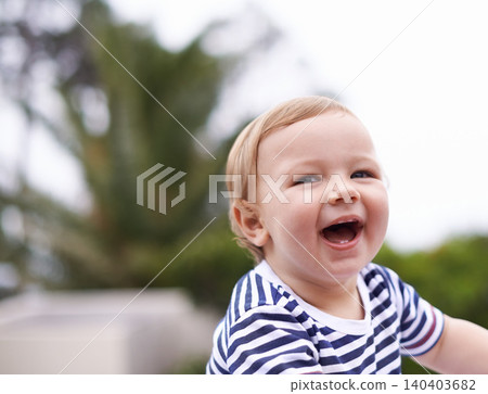Boy, baby and happy for curiosity in outdoors, joy and kid to relax by sky or nature. Child development, toddler and calm or comfortable, wellness and laugh on weekend for health and positive growth 140403682