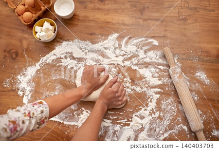 Chef, hands and recipe for dough on table, baking in kitchen and above process in bakery. Person, prepare and press bread with flour for meal prep and learning information from guide in book Chef, hands and recipe for dough on table, baking in kitchen and above process in bakery. Person, prepare and press bread with flour for meal prep and learning information from guide in book 140403703