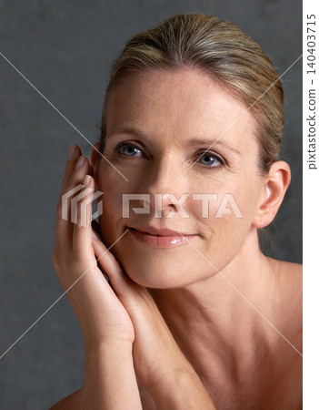 Face, beauty and memory with mature woman in studio on gray background for aesthetic wellness. Skincare, thinking and relax with natural skin person at spa for antiaging cosmetics or treatment 140403715