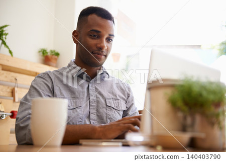 Black man, typing and laptop for remote work from cafe, restaurant and coffee shop in creative career. African male person, writer or freelancer for media website, social networks or blogging 140403790
