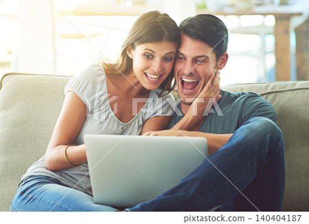 Excited couple, laptop and sofa with hug for good news, winning or giveaway in living room at home. Happy man and woman with smile on computer in celebration for promotion, deal or discount at house Excited couple, laptop and sofa with hug for good news, winning or giveaway in living room at home. Happy man and woman with smile on computer in celebration for promotion, deal or discount at house 140404187