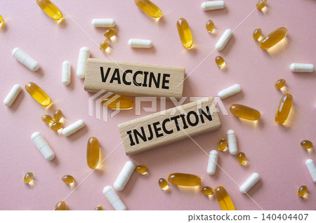 Vaccine Injection symbol. Concept word Vaccine Injection on wooden blocks. Beautiful pink background with pills. Medicine and Vaccine Injection. Copy space Vaccine Injection symbol. Concept word Vaccine Injection on wooden blocks. Beautiful pink background with pills. Medicine and Vaccine Injection. Copy space 140404407