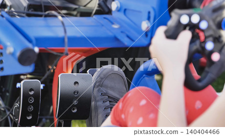 Gamer playing racing video game simulation using steering wheel and pedals Gamer playing racing video game simulation using steering wheel and pedals 140404466