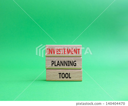 Investment planning tool symbol. Concept word Investment planning tool on wooden blocks. Beautiful green background. Business and Investment planning tool. Copy space 140404470