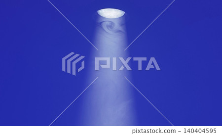 Bright stage spotlight illuminating an area with hazy smoke against a deep blue background Bright stage spotlight illuminating an area with hazy smoke against a deep blue background 140404595