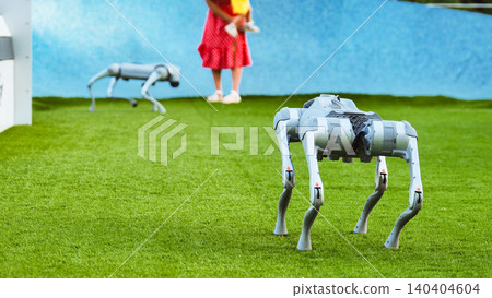 Robot dogs exploring artificial grass with a person, showcasing future technology Robot dogs exploring artificial grass with a person, showcasing future technology 140404604