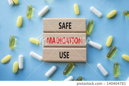 Safe Medication Use symbol. Concept words Safe Medication Use on wooden blocks. Beautiful blue background with pills. Healthcare and Safe Medication Use concept. Copy space. 140404781