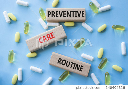 Preventive care routine symbol. Concept words Preventive care routine on wooden blocks. Beautiful blue background with pills. Healthcare and Preventive care routine concept. Copy space. 140404816