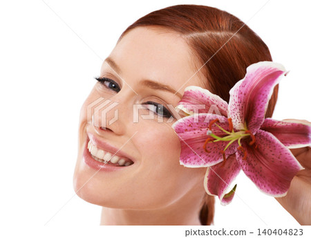 Skincare, flower and portrait of woman in studio with natural, organic and beauty routine for wellness. Cosmetic, glow and person with floral plant for face dermatology treatment by white background. 140404823