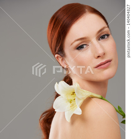 Portrait, skincare and woman with flower, lily and natural beauty isolated on a gray studio background mockup. Face, organic and ginger model with floral cosmetics for glow, wellness and makeup 140404827