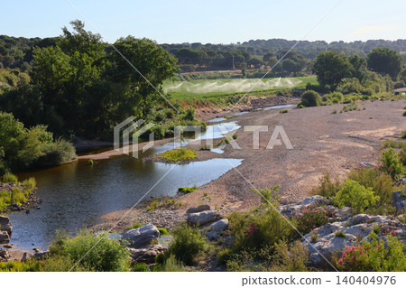 Agricultural irrigation next to a dry riverbed during drought at Ribeira da Raia, Acude do Furadouro. Agricultural irrigation next to a dry riverbed during drought at Ribeira da Raia, Acude do Furadouro. 140404976