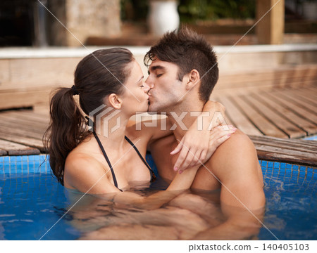 Couple, relax in pool and kiss outdoor, love and connection with summer vacation at resort or hotel. People in water, swimming or hug in hot tub for romantic date or getaway with trust and bonding Couple, relax in pool and kiss outdoor, love and connection with summer vacation at resort or hotel. People in water, swimming or hug in hot tub for romantic date or getaway with trust and bonding 140405103