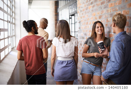 Students, men and women on campus friends, talking and standing together in corridor. Diversity, people and group in college for education, communication and discussion for conversation while smiling 140405180