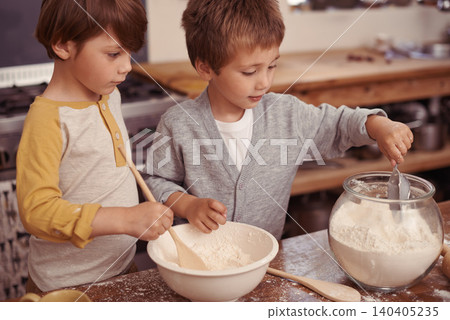 Boys, baking and creative in kitchen with flour and measurement of dry ingredients in bowl for cake. Children, bonding and messy for cookies in home, love and pastry recipe for holiday learning Boys, baking and creative in kitchen with flour and measurement of dry ingredients in bowl for cake. Children, bonding and messy for cookies in home, love and pastry recipe for holiday learning 140405235