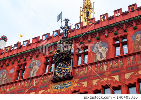 Close-up of red town hall with clock, paintings and ornaments in Basel, Switzerland Close-up of red town hall with clock, paintings and ornaments in Basel, Switzerland 140405310