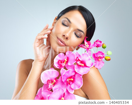Woman, flower and smile for beauty, cosmetology and natural makeup on light grey background. Plant, healthy female person and glow for eco friendly, organic and green cosmetics for wellness or pamper Woman, flower and smile for beauty, cosmetology and natural makeup on light grey background. Plant, healthy female person and glow for eco friendly, organic and green cosmetics for wellness or pamper 140405334