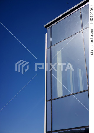 Modern glass building facade against clear blue sky. Modern glass building facade against clear blue sky. 140405505