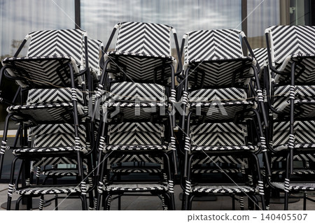 Geometric pattern of stacked black and white bistro chairs. Geometric pattern of stacked black and white bistro chairs. 140405507