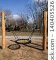 Wooden nest swing on modern outdoor playground in park. 140405526