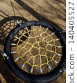 Close-up top view of round rope nest swing structure. 140405527