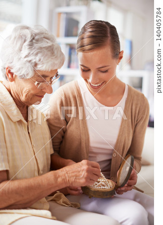 Mother, elderly woman and daughter with pearl necklace, home and conversation in a living room. Family, old lady and adult on a couch, relaxing and discussion with jewelry, present or inheritance Mother, elderly woman and daughter with pearl necklace, home and conversation in a living room. Family, old lady and adult on a couch, relaxing and discussion with jewelry, present or inheritance 140405784