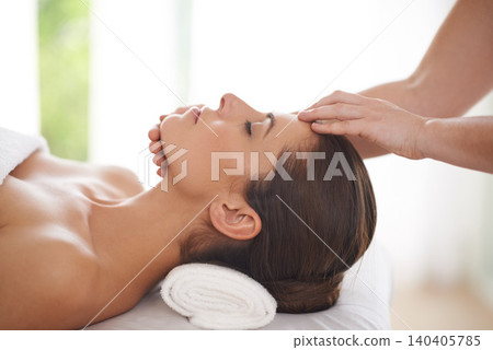 Spa, massage and hands on head of woman to relax on table for skin care, treatment or facial. Calm, person and girl in salon or resort on holiday or vacation with wellness and healthy stress relief Spa, massage and hands on head of woman to relax on table for skin care, treatment or facial. Calm, person and girl in salon or resort on holiday or vacation with wellness and healthy stress relief 140405785