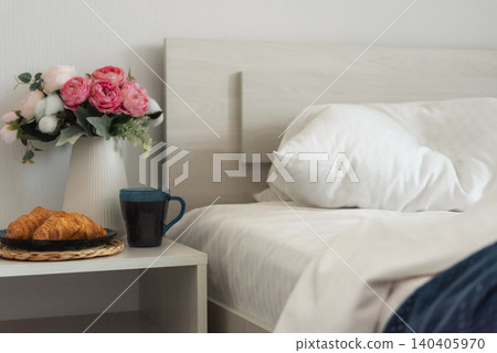 Croissants and coffee beside an unmade bed in a cozy bedroom Croissants and coffee beside an unmade bed in a cozy bedroom 140405970