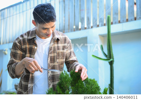 A man making bonsai pruning with precision care and craftsmanship A man making bonsai pruning with precision care and craftsmanship 140406011