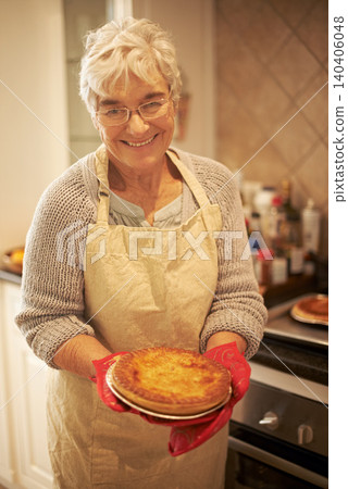 Elderly lady, pie and smiling in kitchen at home for baking, cooking or retirement leisure. Happy, and proud senior person or grandmother with glasses for food recipes, meals and hobby in house Elderly lady, pie and smiling in kitchen at home for baking, cooking or retirement leisure. Happy, and proud senior person or grandmother with glasses for food recipes, meals and hobby in house 140406048