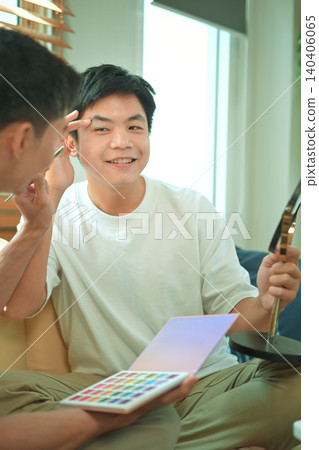 Photo set of LGBTQ applying glitter makeup with partner 140406065