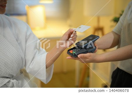 Closeup woman paying with card at spa using terminal , Wellness business concept Closeup woman paying with card at spa using terminal , Wellness business concept 140406078