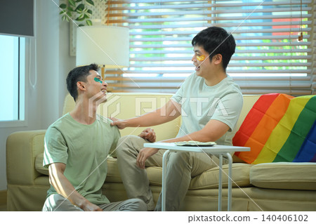 LGBTQ partners sharing skincare routine together applying eye mask LGBTQ partners sharing skincare routine together applying eye mask 140406102