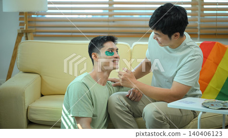 LGBTQ partners sharing skincare routine together applying eye mask LGBTQ partners sharing skincare routine together applying eye mask 140406123