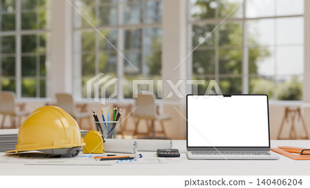 Modern engineering desk with blank laptop screen safety helmet and drafting equipment in office Modern engineering desk with blank laptop screen safety helmet and drafting equipment in office 140406204
