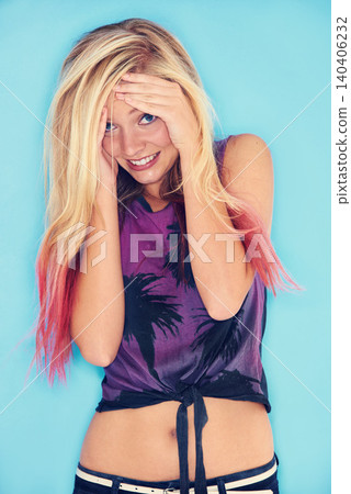 Portrait, blue background and fashion for gen z girl with smile in studio, unique and punk with outfit. Youth, fun and female person with hands on face, embarrassed and cool as model for summer Portrait, blue background and fashion for gen z girl with smile in studio, unique and punk with outfit. Youth, fun and female person with hands on face, embarrassed and cool as model for summer 140406232