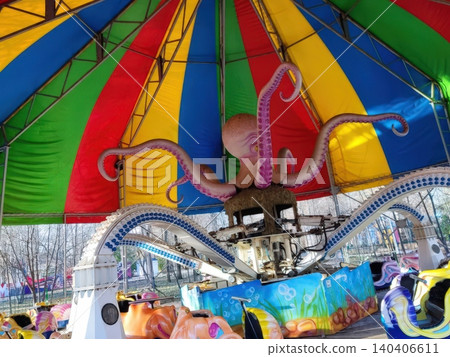 Vibrant octopus carnival ride under a colorful canopy Vibrant octopus carnival ride under a colorful canopy 140406611