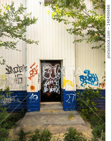 Urban street art on doorway with graffiti and vivid colors in green setting Urban street art on doorway with graffiti and vivid colors in green setting 140406666