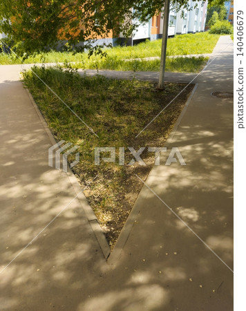 Triangular patch of grass in urban setting with shadows and pathways Triangular patch of grass in urban setting with shadows and pathways 140406679