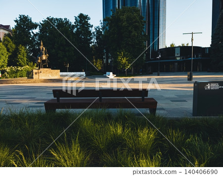 Modern park with bench and urban architecture in bright daylight Modern park with bench and urban architecture in bright daylight 140406690
