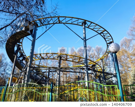 Vibrant roller coaster in a bright autumn amusement park setting Vibrant roller coaster in a bright autumn amusement park setting 140406709