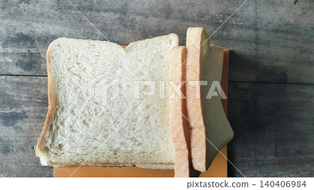 Sliced white bread on a rustic wooden table background Sliced white bread on a rustic wooden table background 140406984