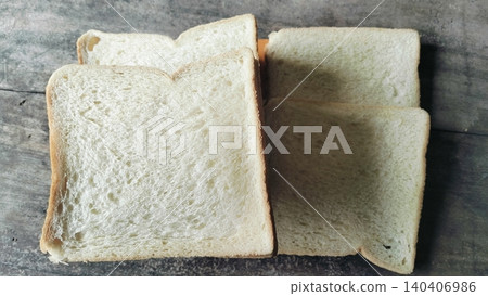 Sliced white bread on a rustic wooden table background Sliced white bread on a rustic wooden table background 140406986