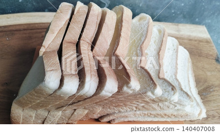 Sliced white bread on a rustic wooden table background Sliced white bread on a rustic wooden table background 140407008
