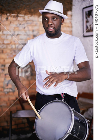 Performance, drum or carnival with a black man playing an instrument in a festival in Rio de Janeiro. Brazil, rhythm or party with a musician, performer or artist banging to create a beat in show Performance, drum or carnival with a black man playing an instrument in a festival in Rio de Janeiro. Brazil, rhythm or party with a musician, performer or artist banging to create a beat in show 140407075