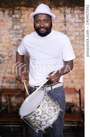 Portrait, drums or carnival with a black man playing an instrument in a festival in Rio de Janeiro. Brazil, ready or party with a male musician, performer or artist banging on a drum to create a beat Portrait, drums or carnival with a black man playing an instrument in a festival in Rio de Janeiro. Brazil, ready or party with a male musician, performer or artist banging on a drum to create a beat 140407092