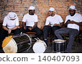 Music, drums or men in band on break or playing an instrument in a festival in Rio de Janeiro. Brazil, phone or group of male musicians, performers or artists in discussion or conversation to relax 140407093