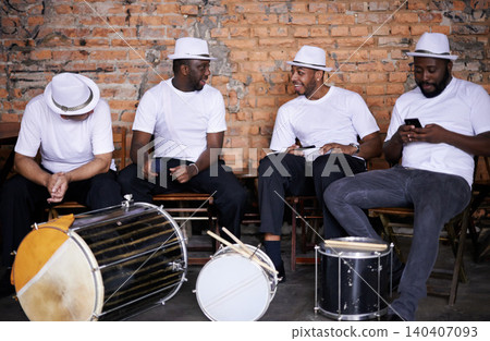 Music, drums or men in band on break or playing an instrument in a festival in Rio de Janeiro. Brazil, phone or group of male musicians, performers or artists in discussion or conversation to relax Music, drums or men in band on break or playing an instrument in a festival in Rio de Janeiro. Brazil, phone or group of male musicians, performers or artists in discussion or conversation to relax 140407093