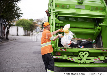 Garbage truck, dirt and man with collection service on street in city for public environment cleaning. Junk, recycling and male person working with waste or trash for road sanitation with transport. Garbage truck, dirt and man with collection service on street in city for public environment cleaning. Junk, recycling and male person working with waste or trash for road sanitation with transport. 140407340
