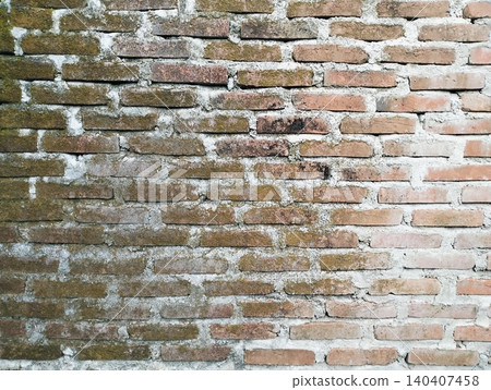 Weathered brickwork background with concrete mortar and green mossy growth. Weathered brickwork background with concrete mortar and green mossy growth. 140407458