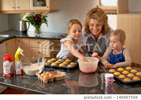 Grandmother, children and baking cupcakes or helping with icing decorations or learning creativity, bonding or teamwork. Woman, siblings and sweet treats or teaching with ingredients, snack or fun Grandmother, children and baking cupcakes or helping with icing decorations or learning creativity, bonding or teamwork. Woman, siblings and sweet treats or teaching with ingredients, snack or fun 140407508